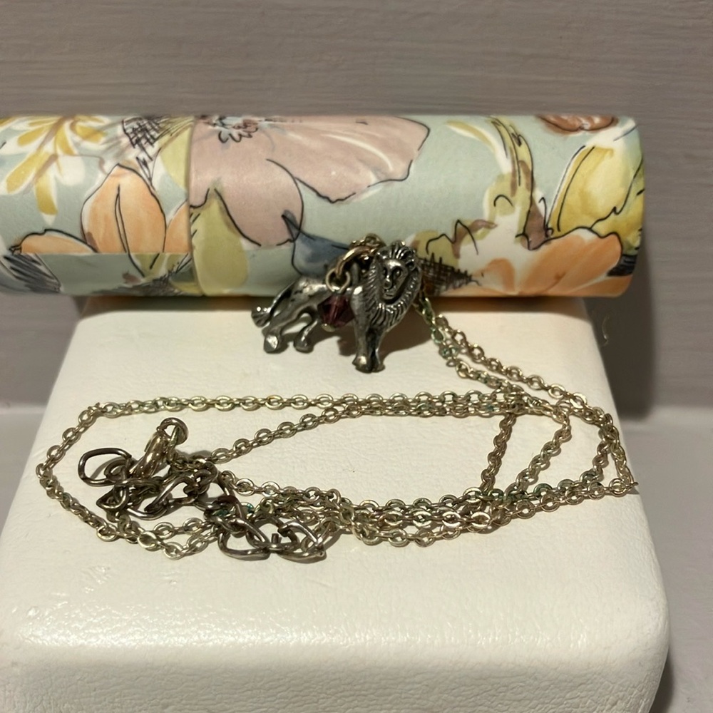 Silver Lion Pendant Necklace with purple glass gem.